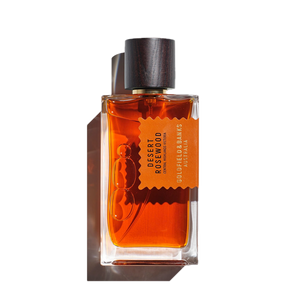 Goldfield & Banks' "Desert Rosewood 100ml Eau de Parfum" comes in a rectangular glass bottle with a dark wooden cap, conveying a luxurious woody fragrance.