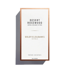 The front view of a Goldfield & Banks Desert Rosewood 100ml Eau de Parfum box reveals an exotic blend, with a design featuring a white background and a copper border, suggesting the woody fragrance within.