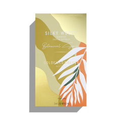 This luxury fragrance box features a gold and orange leaf design with "Silky Woods, Agarwood, Tropical Australia" prominently displayed. It is part of the Botanical Series by Goldfield & Banks and contains 100ml of exquisite Silky Woods Eau De Parfum.