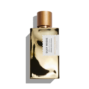 The Goldfield & Banks "Silky Woods 100ml Eau De Parfum" features a glistening golden cap and reflective surface, embodying elegance and allure.