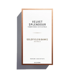 The white perfume box with a copper border is labeled "Velvet Splendour 100ml EdP, Goldfield & Banks." This enchanting scent encapsulates the essence of blooming wildflowers and mimosa trees in Flinders Ranges, South Australia.