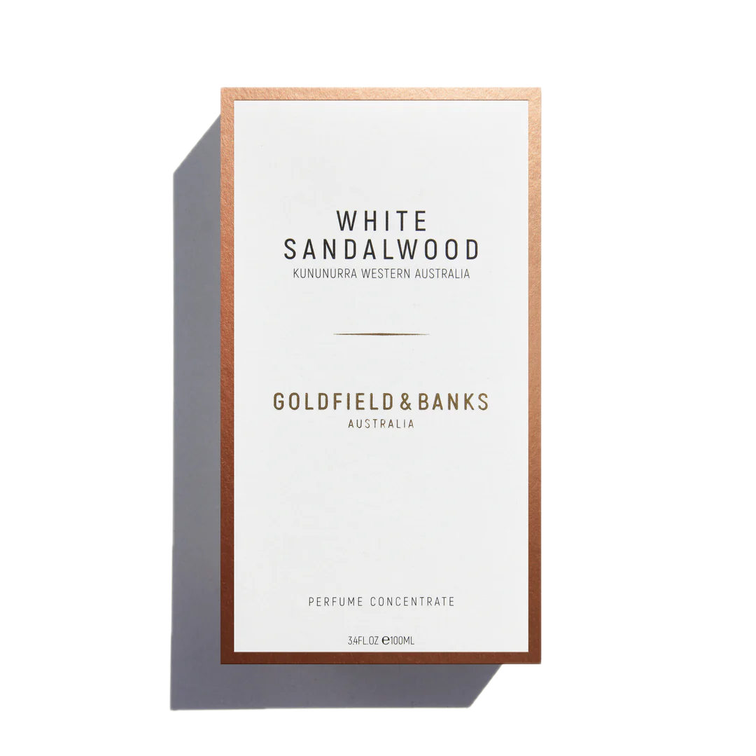 A 100ml bottle of Goldfield & Banks White Sandalwood Eau De Parfum, adorned with the label "Kununurra Western Australia," emanates delicate notes of amber and Turkish rose, encapsulating a sense of luxury and exotic charm.