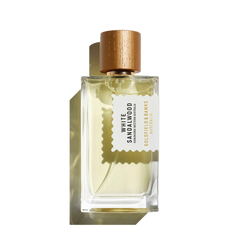 The White Sandalwood 100ml Eau De Parfum by Goldfield & Banks, presented in a clear glass bottle with hints of amber, is adorned with a gold cap and an elegant label, creating a delicate shadow.