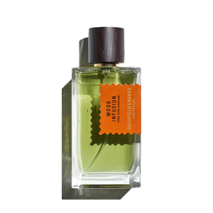 The green perfume, encased in a clear glass bottle and topped with a dark wood cap, displays an orange label reading "Wood Infusion, Goldfield & Banks, Australia." This fragrance weaves together a rich tapestry of Australian woods with subtle notes of rare Sandalwood Album.