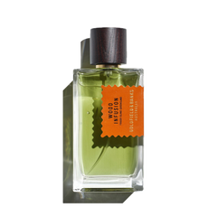 The green perfume, encased in a clear glass bottle and topped with a dark wood cap, displays an orange label reading "Wood Infusion, Goldfield & Banks, Australia." This fragrance weaves together a rich tapestry of Australian woods with subtle notes of rare Sandalwood Album.