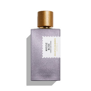 A 100ml bottle of Mystic Bliss Eau De Parfum by Goldfield & Banks, with notes of cedarwood, features a textured purple body and a gold cap, all set gracefully against a white background.