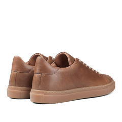 A pair of Goral's Brown Horween Leather Mellor II Sneakers, showcasing premium-quality craftsmanship with beige soles, viewed from the back.