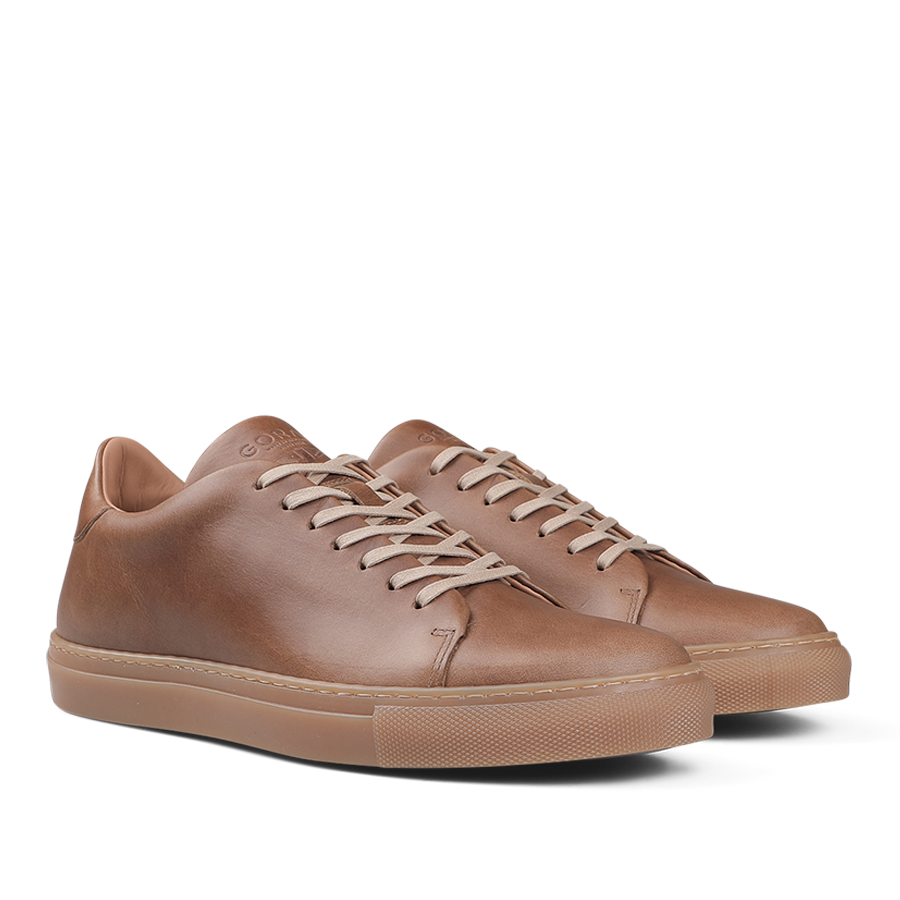 A pair of Goral's Brown Horween Leather Mellor II Sneakers featuring premium-quality leather, white laces, and tan rubber soles.