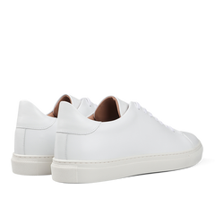 The White Calfskin Mellor II Sneakers by Goral, featuring white laces and a beige inner lining, showcase the craftsmanship of this British footwear brand. These premium sneakers perfectly combine style and comfort when viewed from the back and side.