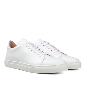 The White Calfskin Mellor II Sneakers by the renowned British brand Goral, featuring premium-quality white leather, white laces, and rubber soles, are showcased against a plain background.