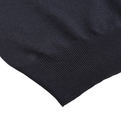 Close-up of the Navy Extra Fine Merino Crew Neck by Gran Sasso, featuring black knitted fabric with ribbed hem detail, perfect for adding warmth to your wardrobe.