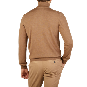 The back view of a man in a Gran Sasso camel beige extra fine merino roll neck sweater.