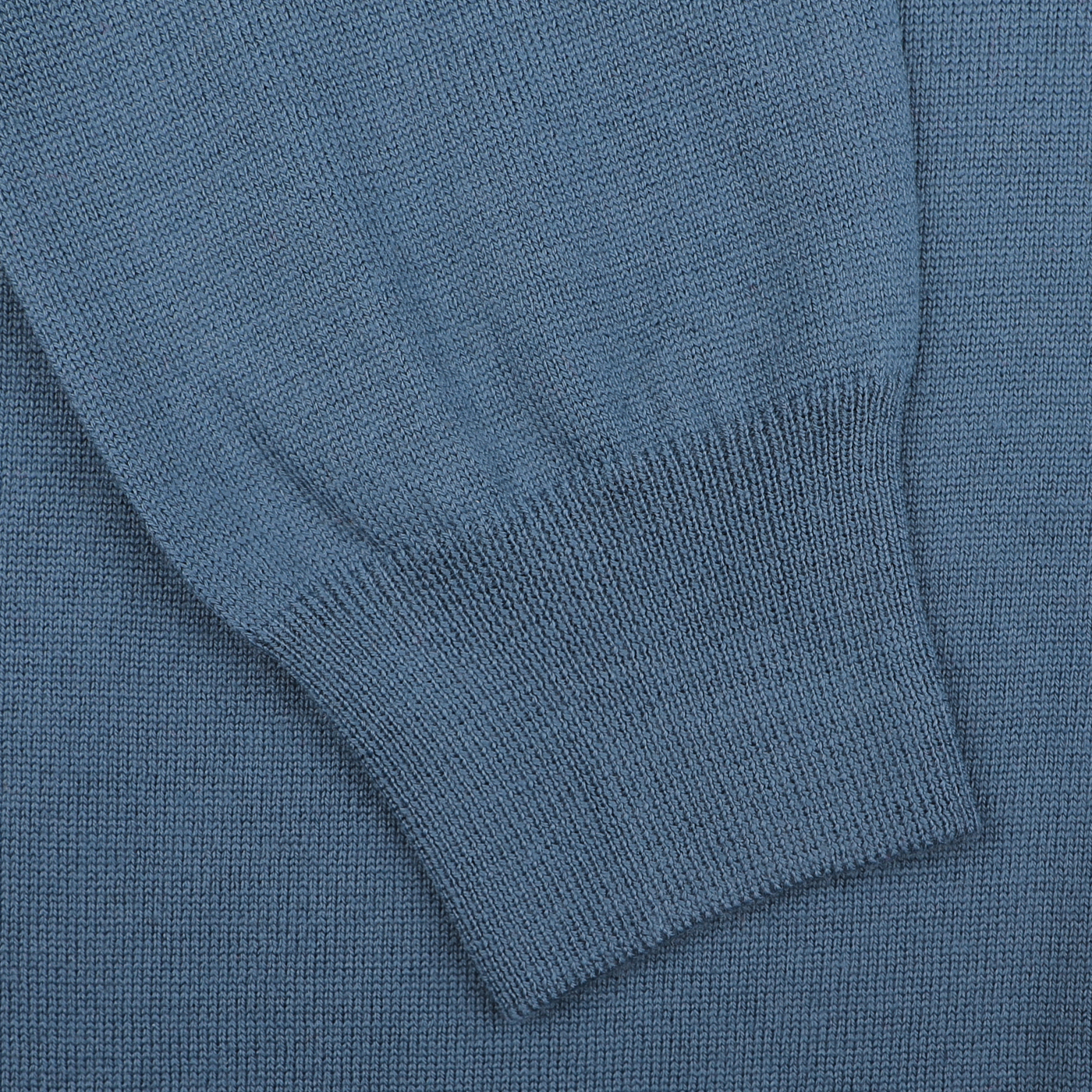 Close-up of a sleeve from the Airforce Blue Extrafine Merino Wool Zip Cardigan by Gran Sasso, featuring a noticeable ribbed cuff detail.