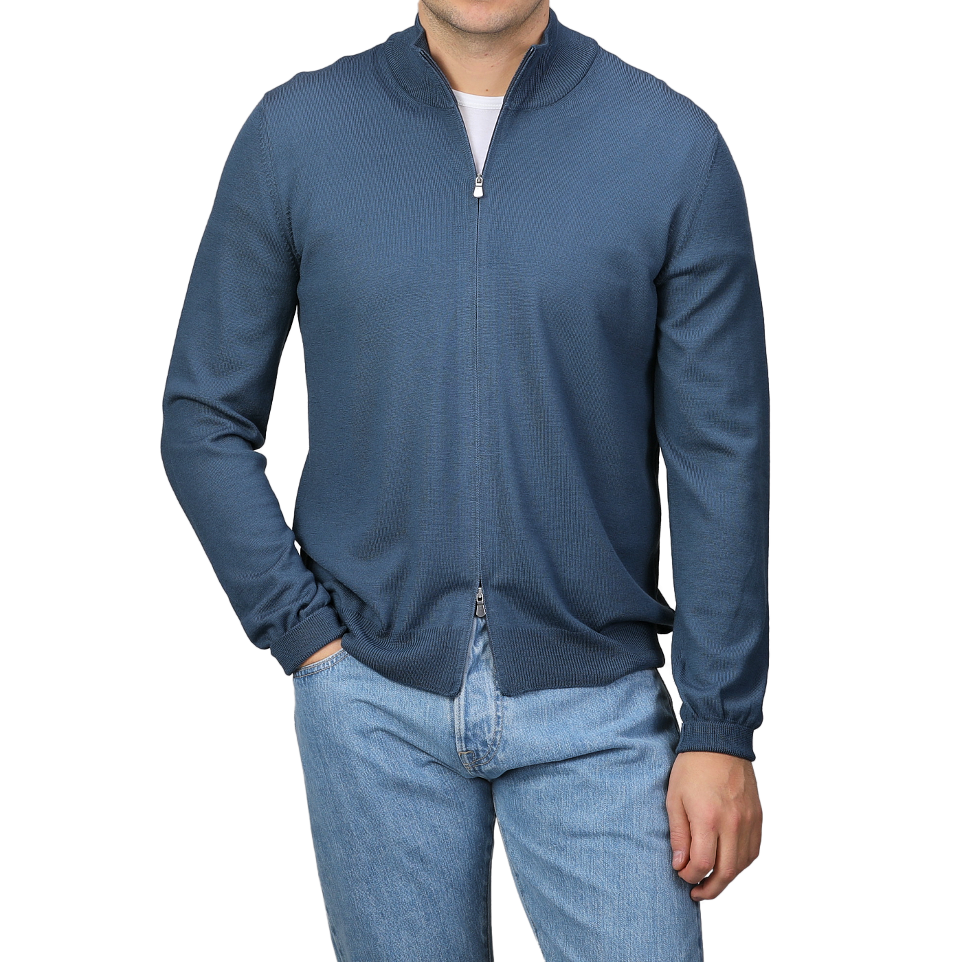 A person wearing a Gran Sasso Airforce Blue Extrafine Merino Wool Zip Cardigan and light blue jeans stands against a plain background.