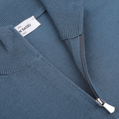 Close-up of a zip cardigan, airforce blue in color and crafted from extrafine merino wool, with a partially open zipper revealing a label that reads "Gran Sasso" and "Italy.