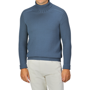 A person wearing an Airforce Blue Rain Wool Rollneck by Gran Sasso and off-white pants.