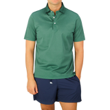 A man wearing a Gran Sasso Aqua Green Cotton Filo Scozia Polo Shirt and shorts.