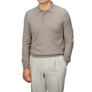 A person wearing a beige Gran Sasso Extra Fine Merino Wool Polo Shirt stands against a plain background, paired perfectly with cream-colored pants.