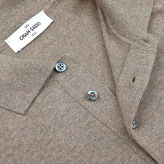 Close-up of a Gran Sasso Beige Extra Fine Merino Wool Polo Shirt highlighting the visible label, button placket, and knit texture.