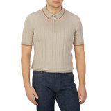 A man wearing a Gran Sasso Taupe Beige Knitted Silk Zip Polo Shirt.
