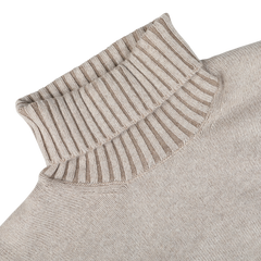 A close-up image of the Beige Melange Pure Cashmere Rollneck by Gran Sasso, showcasing its ribbed collar and neck seam, crafted from luxurious Scottish yarn.