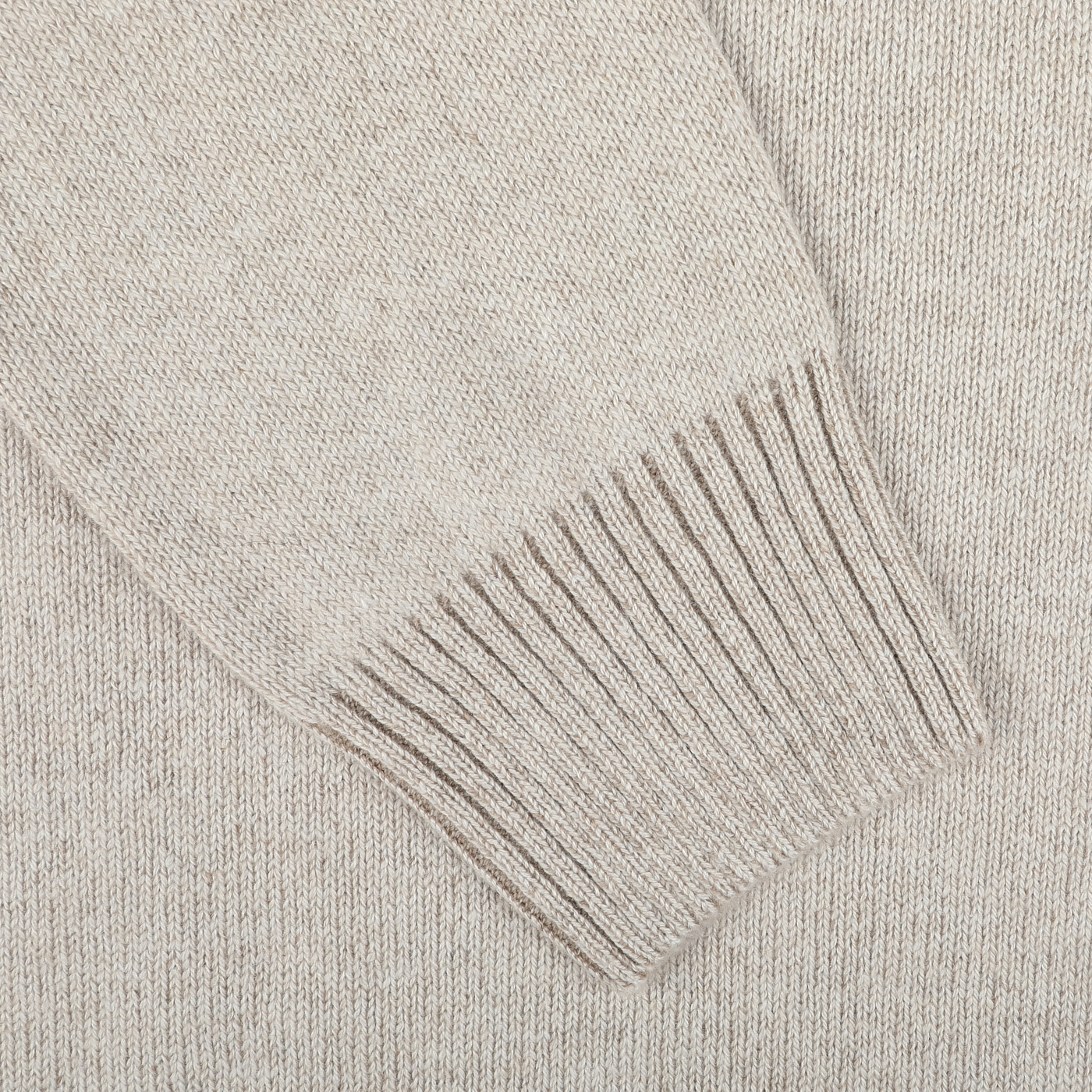 Close-up of a Beige Melange Pure Cashmere Rollneck sleeve showcases the ribbed cuff detail and luxurious texture of the fabric, highlighting Gran Sasso's craftsmanship.