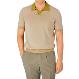 A man wearing a Gran Sasso Beige Cotton Contrast Collar Polo Shirt and khaki pants.