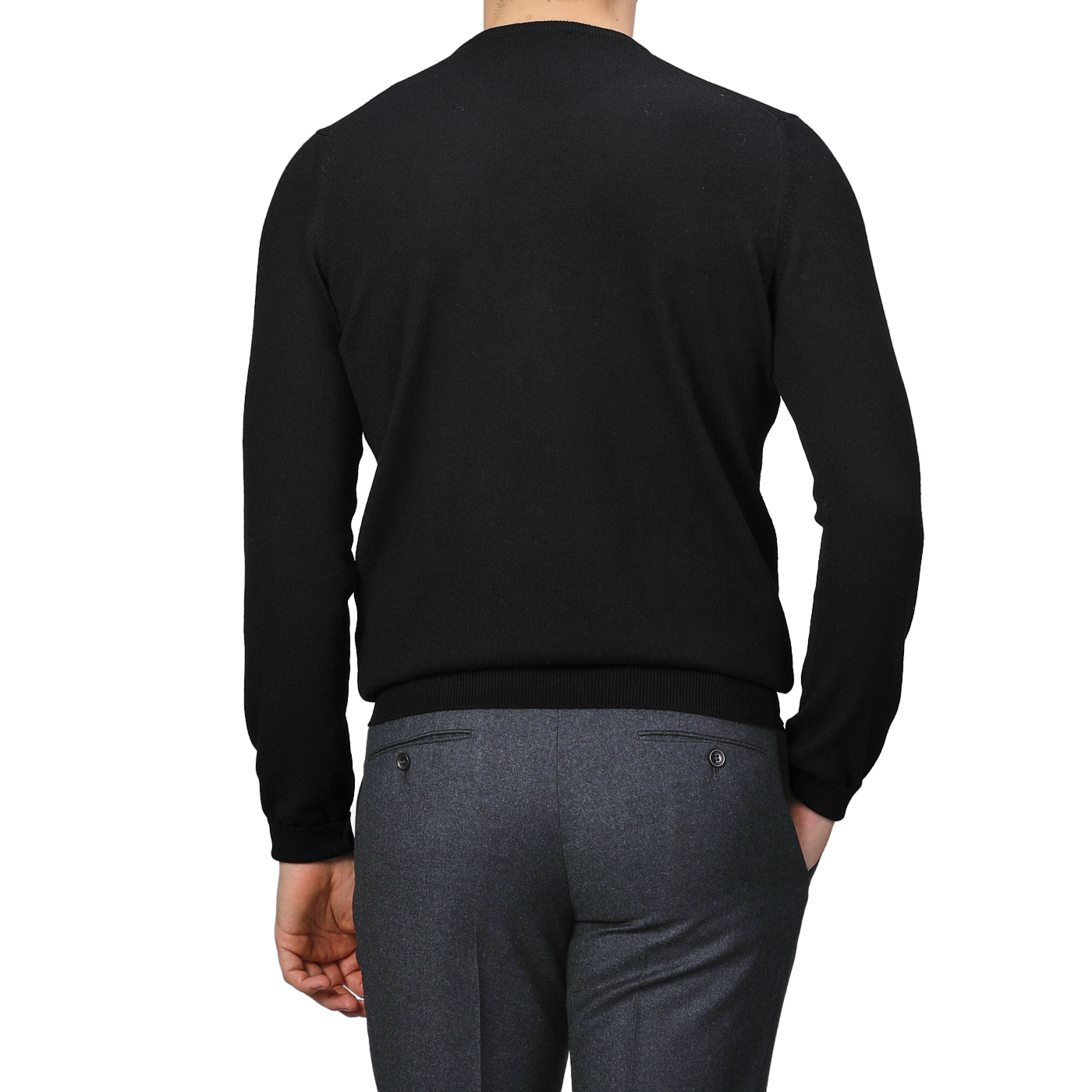 A person is wearing a black cashmere crewneck sweater by Gran Sasso and gray pants, viewed from behind.