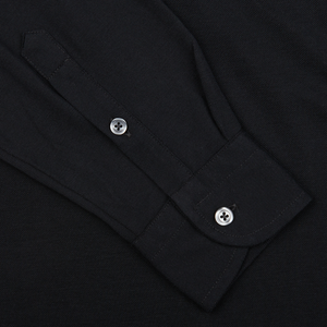 Close-up of a black, Gran Sasso cotton popover shirt cuff with buttons.