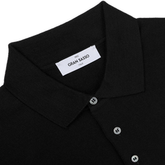 Gran Sasso's Black Extra Fine Merino Wool Polo Shirt showcases a folded collar and button-up front, with the brand’s label elegantly placed inside the collar.