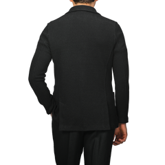 The rear view features a person wearing a slim fit, black knitted blazer with long sleeves, reflecting the elegant style of Gran Sasso's Black Linen Cotton Blazer.