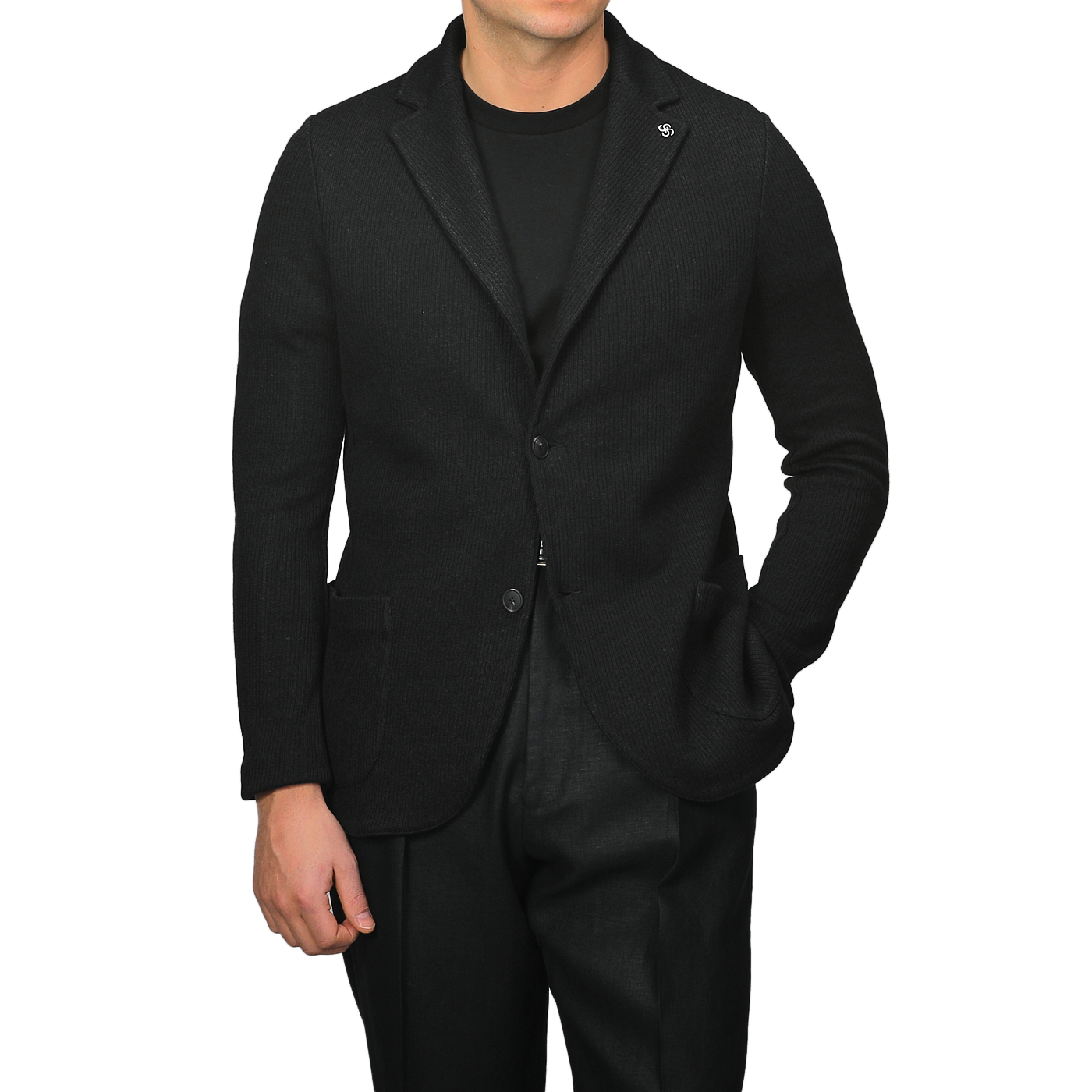 Person in a slim fit Gran Sasso Black Linen Cotton Knitted Blazer over a sleek black shirt, hands casually in pockets, standing against a plain background.