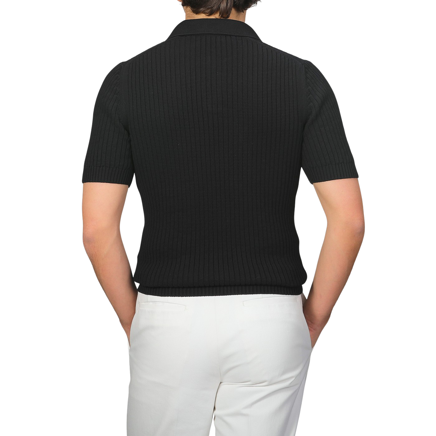 Person wearing a Gran Sasso black organic cotton polo shirt paired with white pants, facing away.