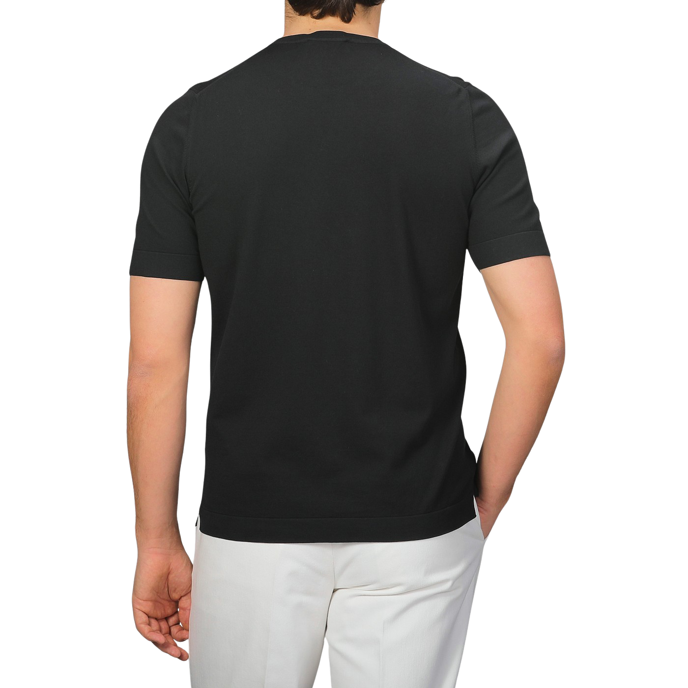 A person is seen from the back wearing Gran Sasso's Black Organic Cotton T-Shirt and white pants, standing against a gray background.