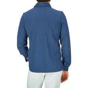 Rear view of a person wearing a Gran Sasso Blue Cotton Jersey Popover Shirt and white formal trousers.