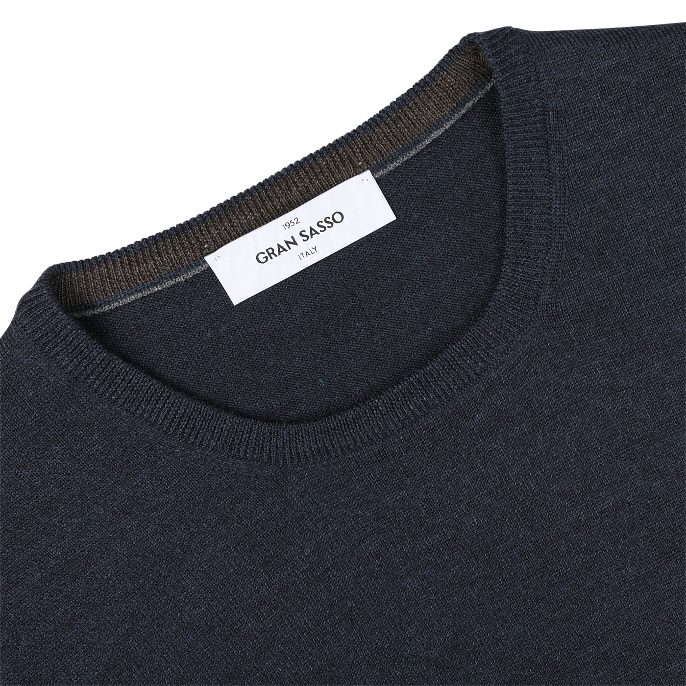 Close-up of a Blue Melange Extra Fine Merino Crew Neck sweater with a white label reading "Gran Sasso" on the collar. The collar edge also features a brown trim, adding an extra layer of warmth.