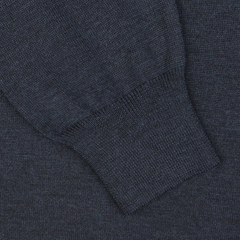 Close-up of a blue melange knitted fabric from Gran Sasso's Blue Melange Extra Fine Merino Crew Neck, showcasing a sleeve with a ribbed cuff that provides an extra layer of warmth.