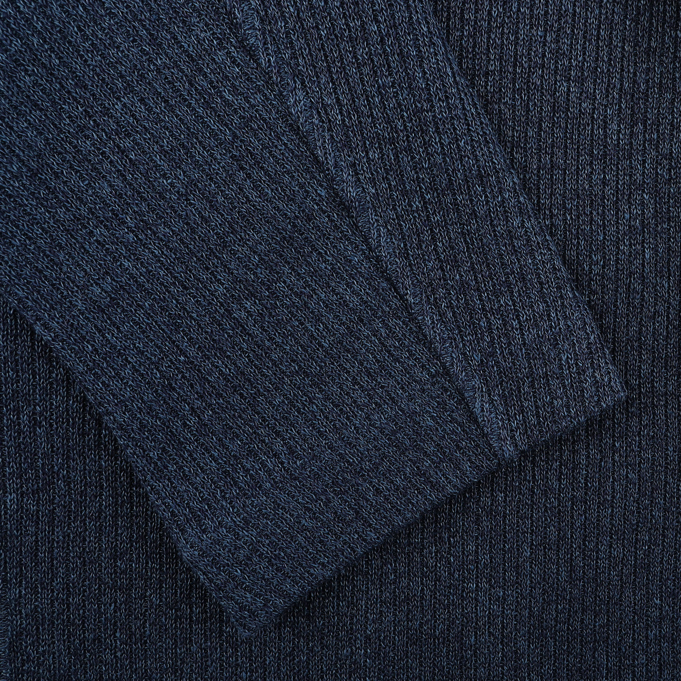 Close-up of a Blue Melange Linen Cotton Knitted Blazer by Gran Sasso, showcasing its dark blue ribbed knit fabric, with visible texture and stitching.