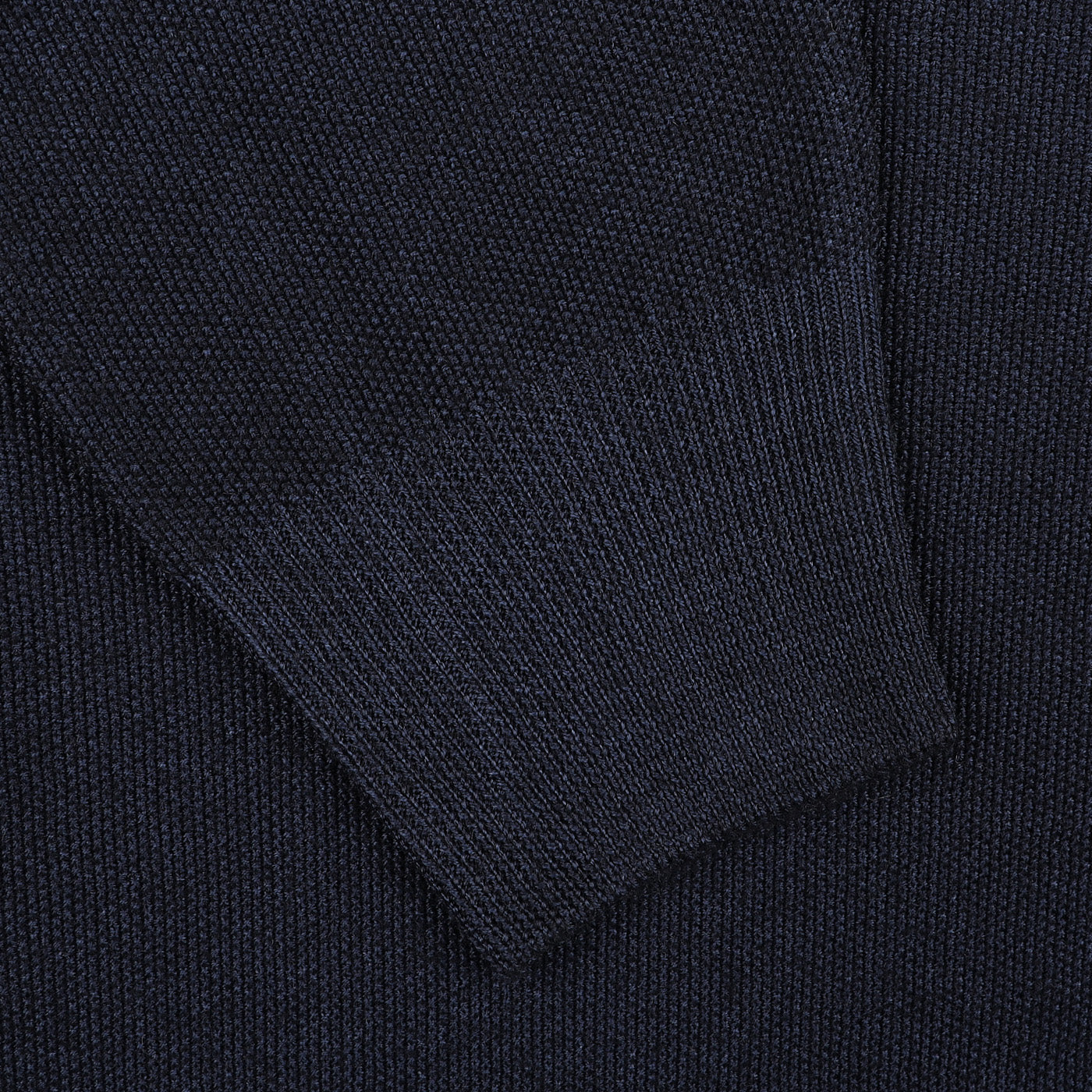 Close-up of a Blue Melange Vintage Wool Zip Cardigan sleeve by Gran Sasso, crafted from virgin wool with a fine ribbing texture and hem detail.