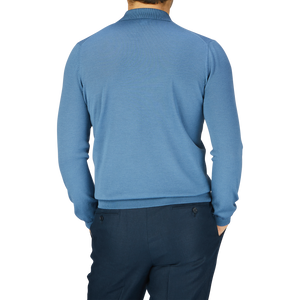 The man is wearing a Blue Travel Wool Knitted LS Polo Shirt from Gran Sasso.