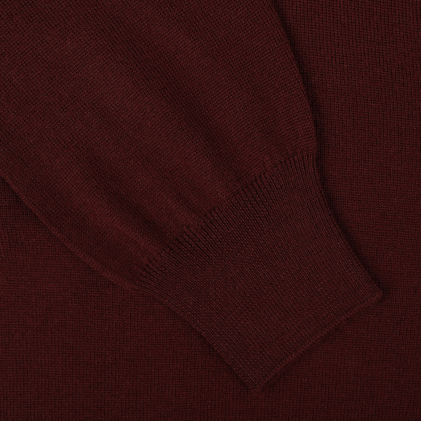 Close-up of a Gran Sasso Bordeaux Extra Fine Merino Wool Cardigan sleeve with a ribbed cuff.