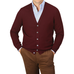 A person is wearing a Bordeaux Extra Fine Merino Wool Cardigan by Gran Sasso over a light blue dress shirt and brown pants.