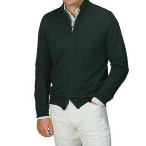 A person wearing a Gran Sasso Bottle Green Extrafine Merino Wool Zip Cardigan over a striped shirt and white pants.