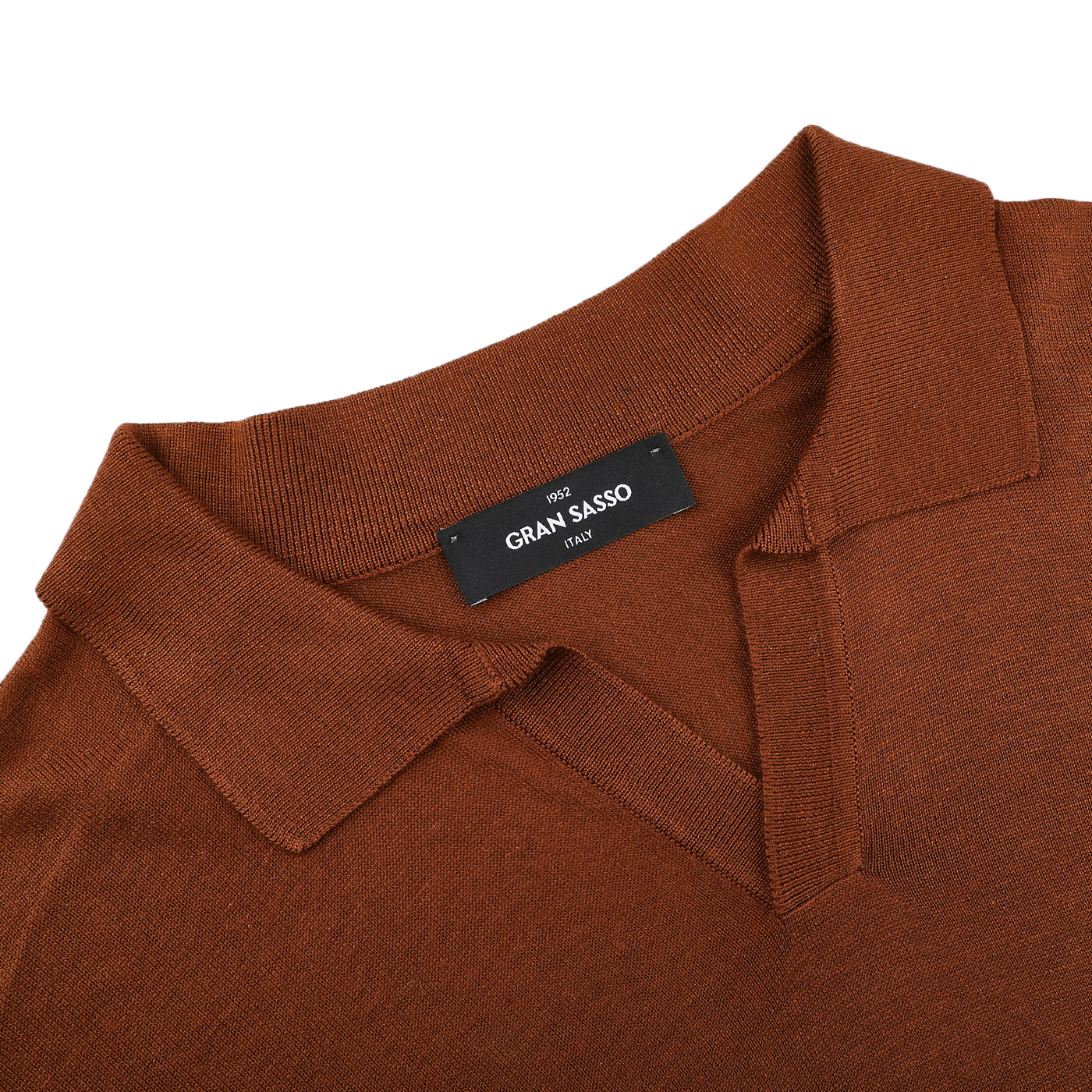 This brick red knitted silk polo shirt, a stylish touch for any summer wardrobe, boasts a visible black label with "Gran Sasso" elegantly displayed inside.