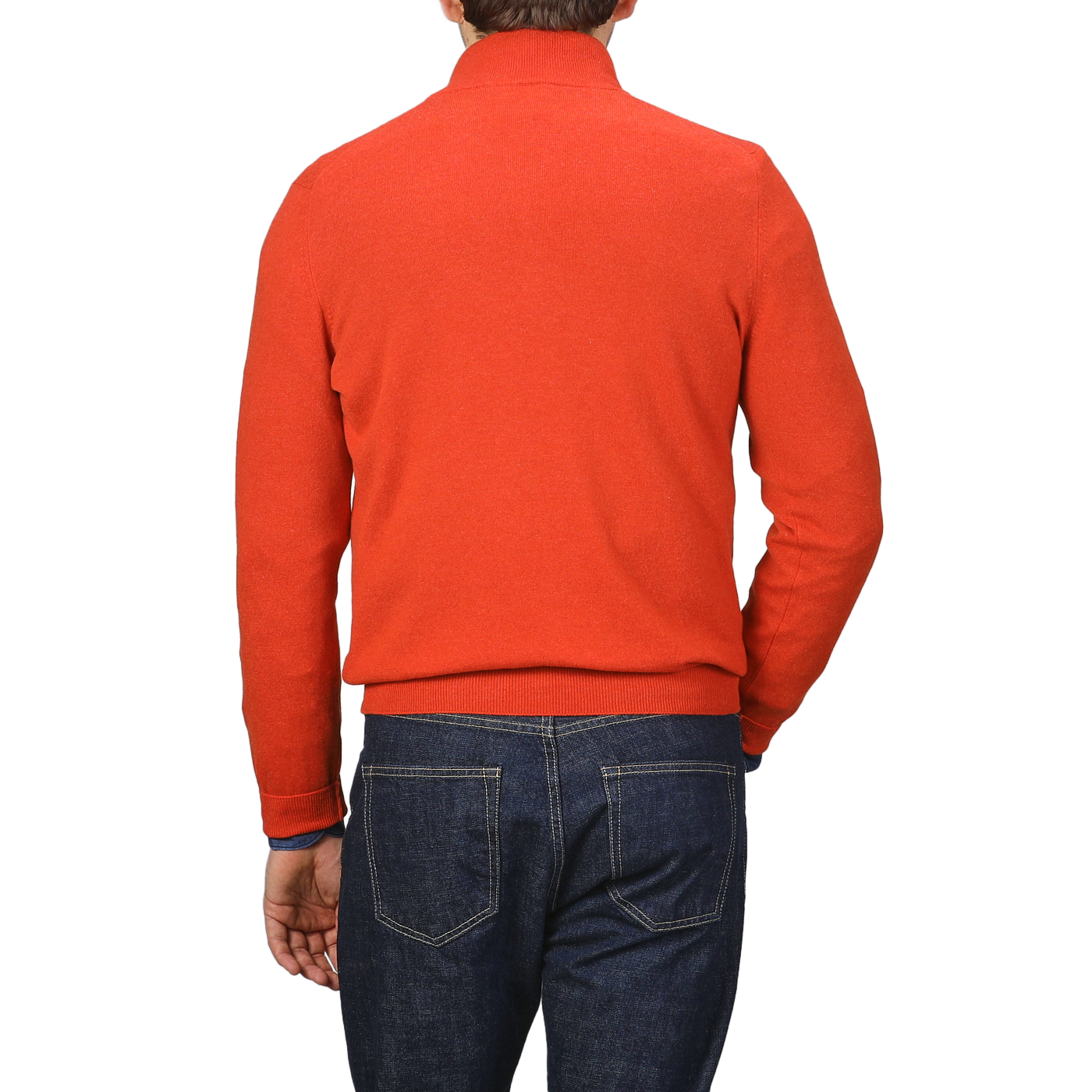 Back view of a person wearing the Gran Sasso Bright Orange Cashmere 1/4 Zip Sweater and dark blue jeans, standing against a plain background, showcasing the elegance of premium knitwear.