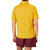 The back view of a man wearing a Gran Sasso Bright Yellow Cotton Filo Scozia Polo Shirt.