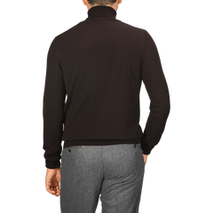 A person is seen from the back wearing a dark Gran Sasso Brown Extra Fine Merino Roll Neck and grey pants.