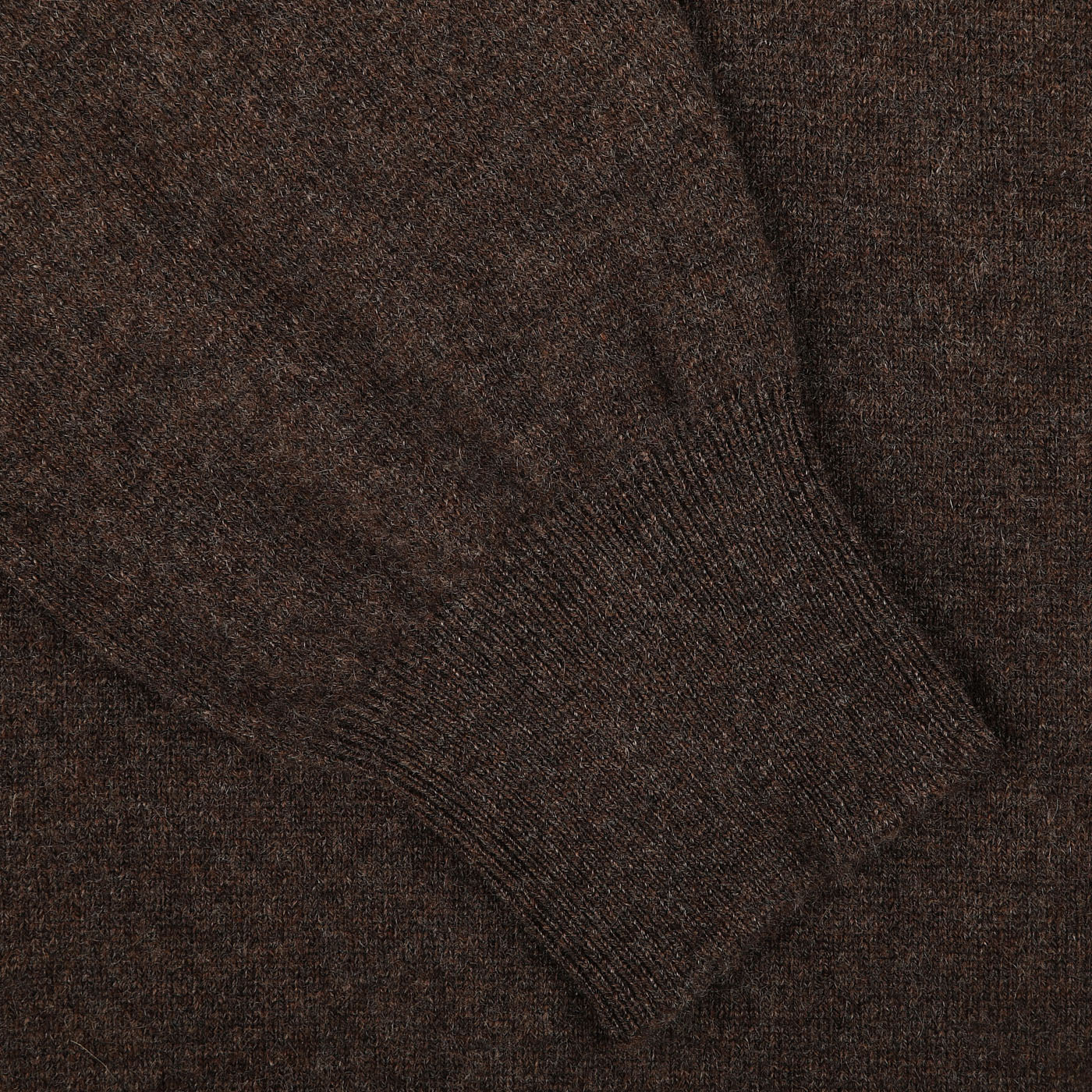 Close-up of a dark brown melange knit sweater sleeve by Gran Sasso, showcasing ribbed cuff detailing on the luxurious Brown Melange Cashmere 1/4 Zip Sweater.