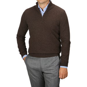 A person is wearing a Gran Sasso Brown Melange Cashmere 1/4 Zip Sweater over a light blue collared shirt, paired with gray trousers. This premium knitwear adds a touch of sophistication while keeping comfort in mind.