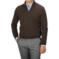 A person is wearing a Gran Sasso Brown Melange Cashmere 1/4 Zip Sweater over a light blue collared shirt, paired with gray trousers. This premium knitwear adds a touch of sophistication while keeping comfort in mind.